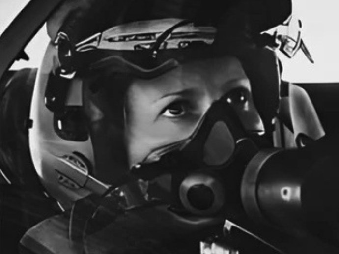 Afterburner speaker Jasmine Young in helmet and oxygen mask in a fast-jet cockpit