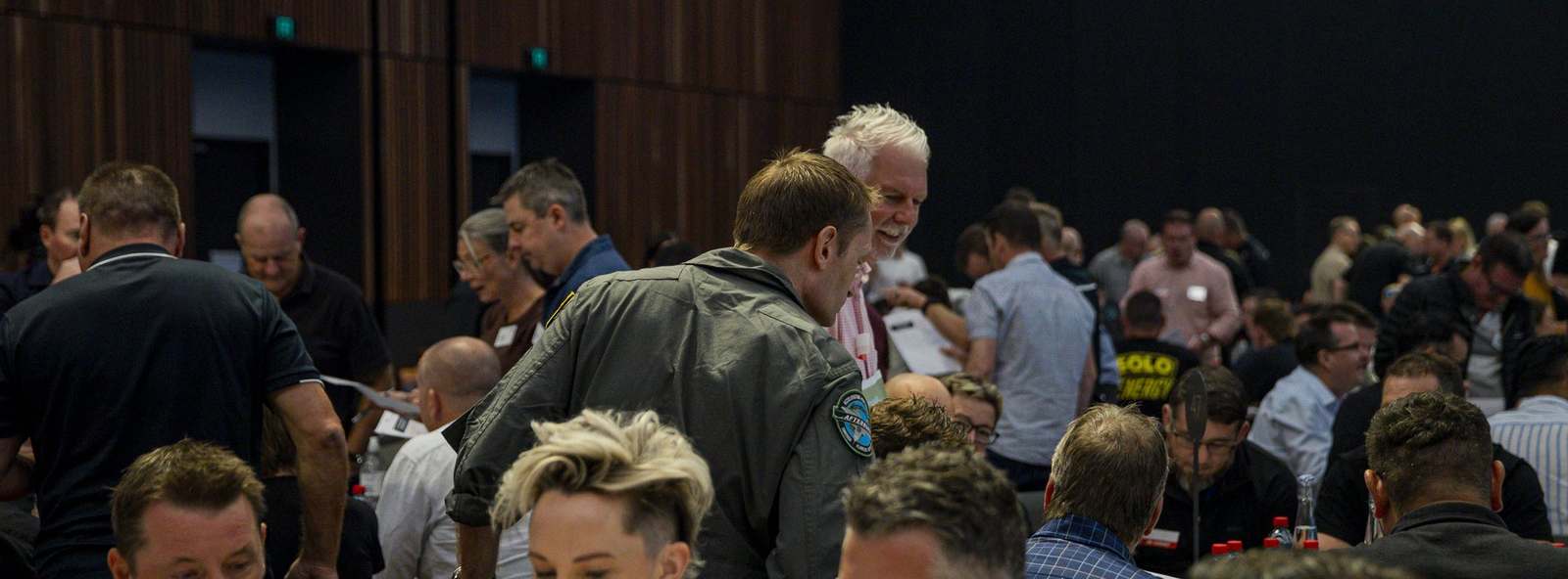 Delegates working at their mission tables with an Afterburner facilitator during a Top Gun Experience