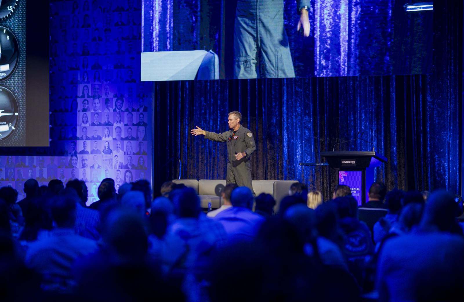 An Afterburner pilot on stage in front of a full room